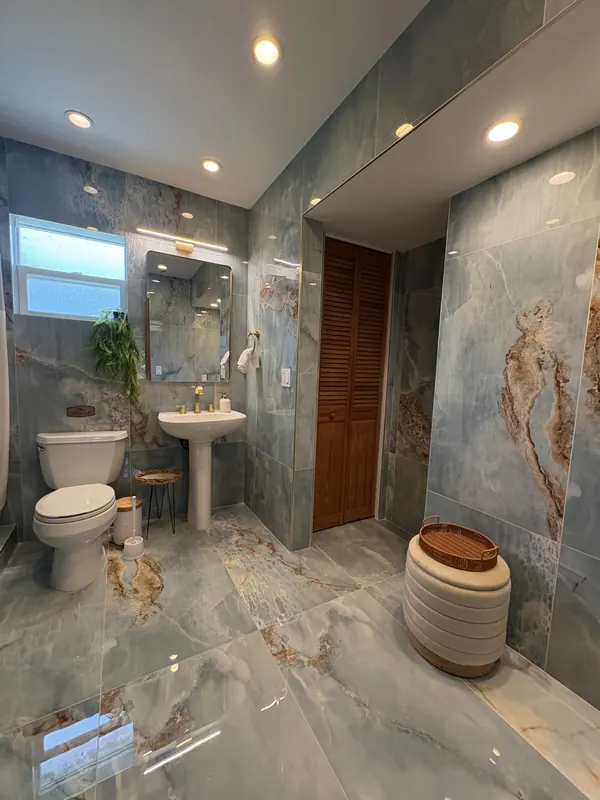 Blue coastal bathroom with gold fixtures